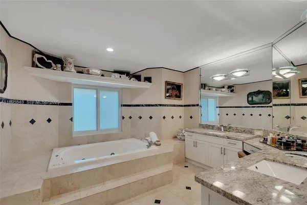 a bathroom with a bathtub sink and mirror