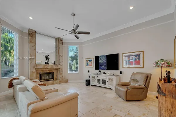 a living room with furniture a flat screen tv and a fireplace