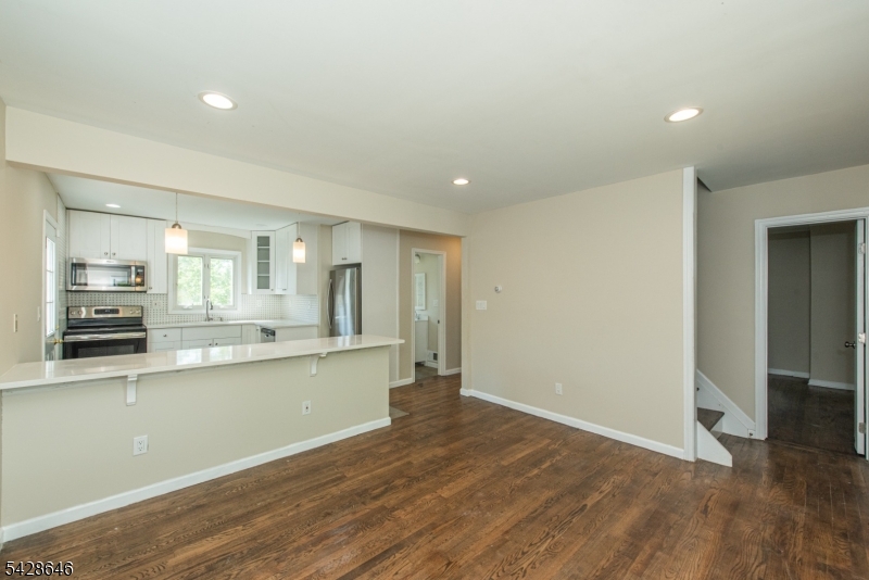 537 Dell Road Mount Arlington, NJ 07850 - Photo 11 of 23 a large kitchen with stainless steel appliances granite countertop a large counter top and a stove with wooden floor
