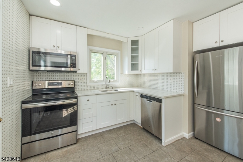 537 Dell Road Mount Arlington, NJ 07850 - Photo 13 of 23 a kitchen with granite countertop cabinets stainless steel appliances and a window