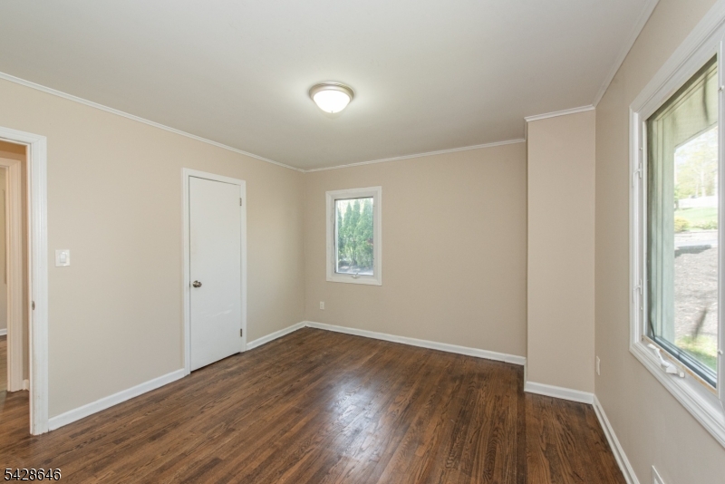 537 Dell Road Mount Arlington, NJ 07850 - Photo 4 of 23 an empty room with wooden floor and windows