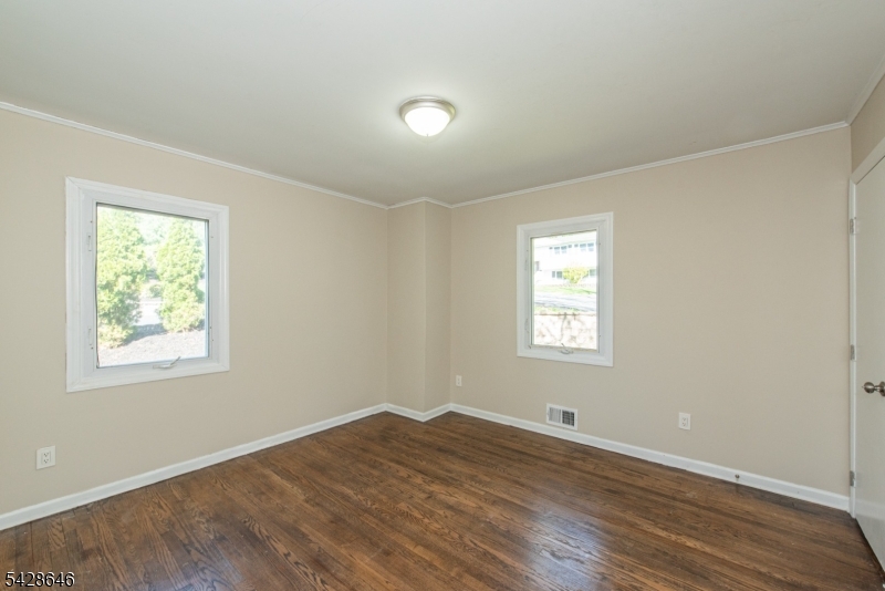 537 Dell Road Mount Arlington, NJ 07850 - Photo 5 of 23 a view of empty room with wooden floor and fan