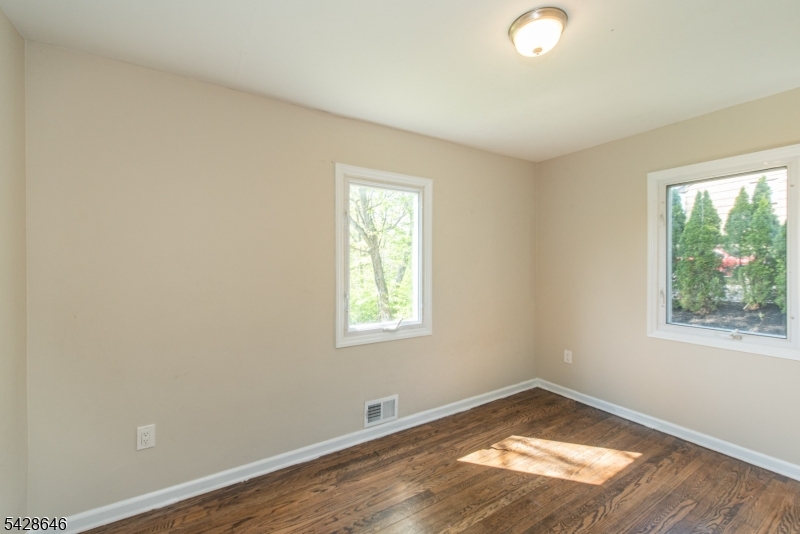 537 Dell Road Mount Arlington, NJ 07850 - Photo 6 of 23 an empty room with wooden floor and windows