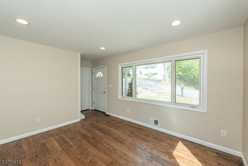 537 Dell Road Mount Arlington, NJ 07850 - Photo 9 of 23 a view of an empty room with wooden floor and a window