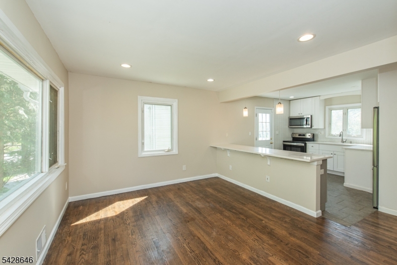 537 Dell Road Mount Arlington, NJ 07850 - Photo 10 of 23 a kitchen with white cabinets and wooden floor