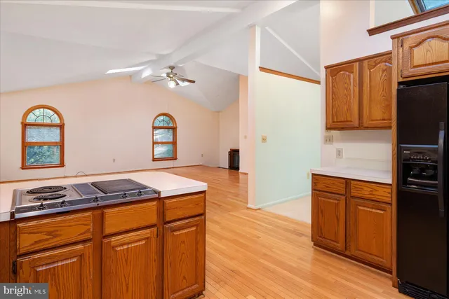 an empty room with closet and a chandelier fan