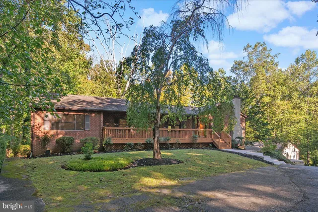 a balcony with wooden floor and yard in the back