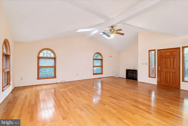 a view of living room with kitchen island and wooden floor