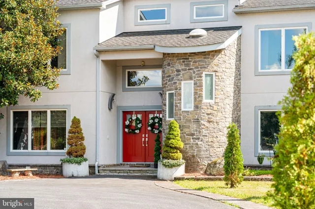 a view of a dining room with furniture and a chandelier