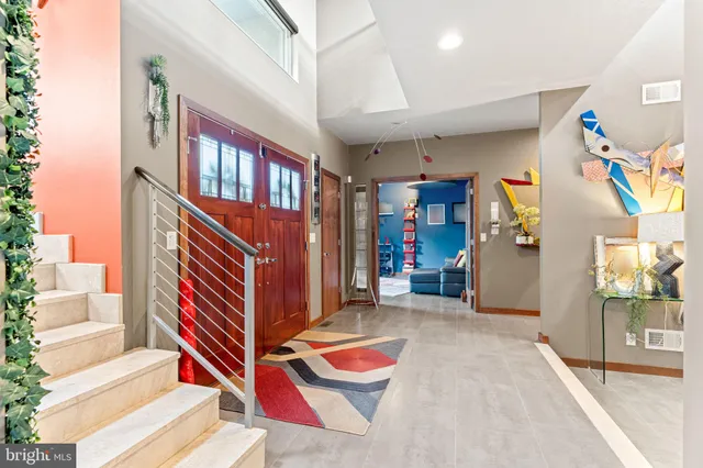 a living room with furniture a couch and a large window