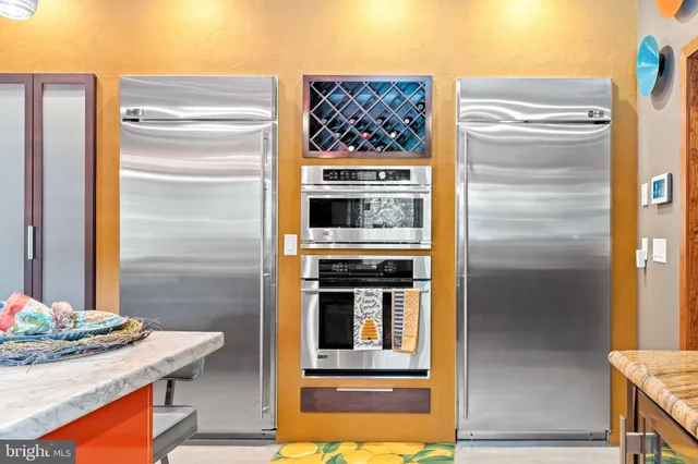 a bedroom with a bed and a flat tv screen on the dresser