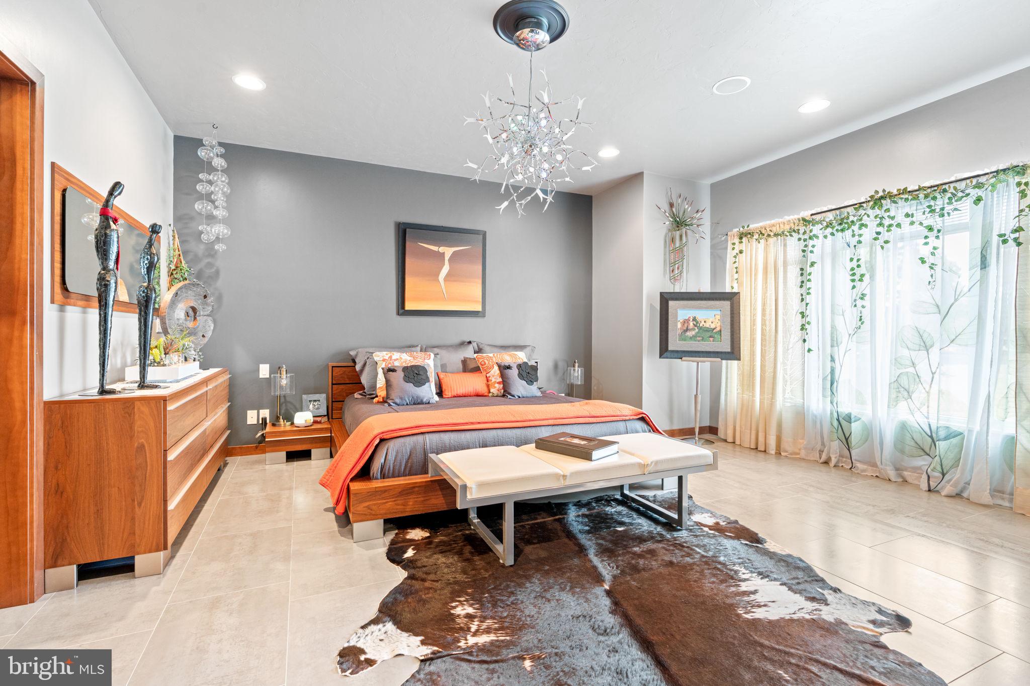 75 Cavalry Field Road Gettysburg, PA 17325 - Photo 43 of 147 a spacious bedroom with a bed and a chandelier