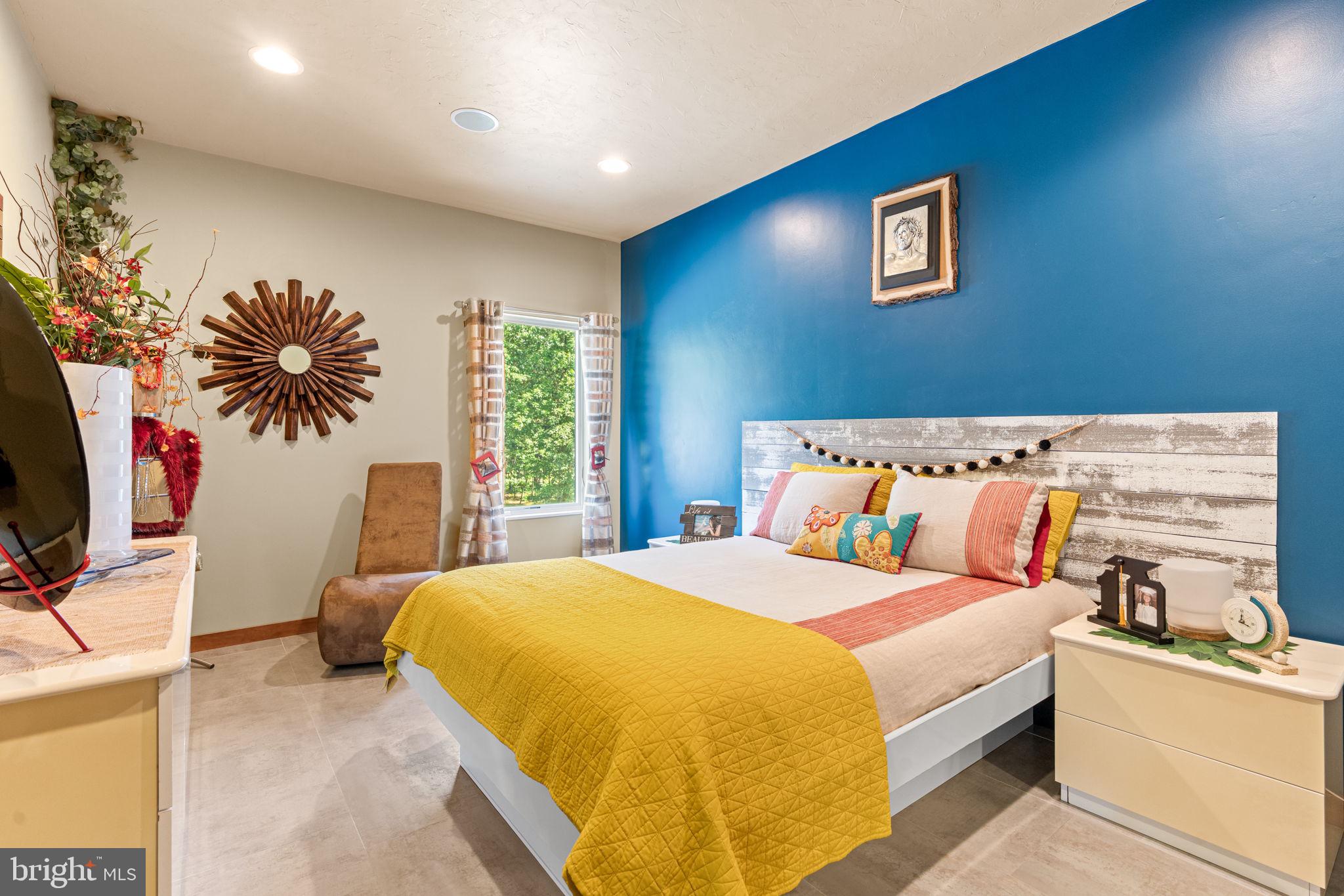 75 Cavalry Field Road Gettysburg, PA 17325 - Photo 69 of 147 a bedroom with a bed and a flat tv screen on the dresser