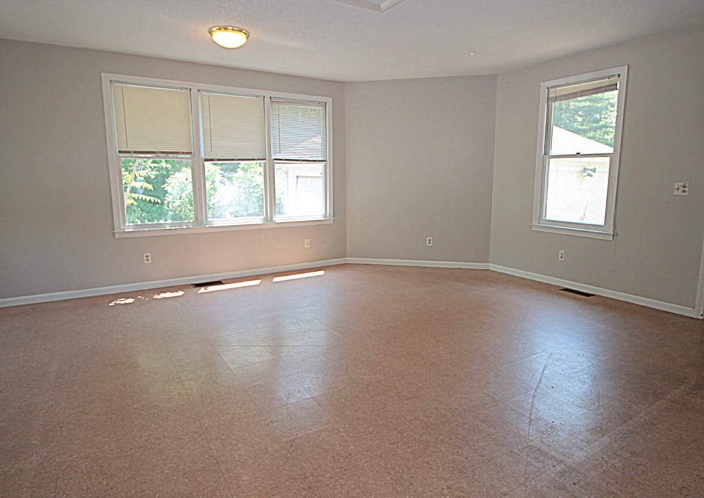 1644 Allen Street Springfield, MA 01118 - Photo 13 of 27 an empty room with wooden floor and windows