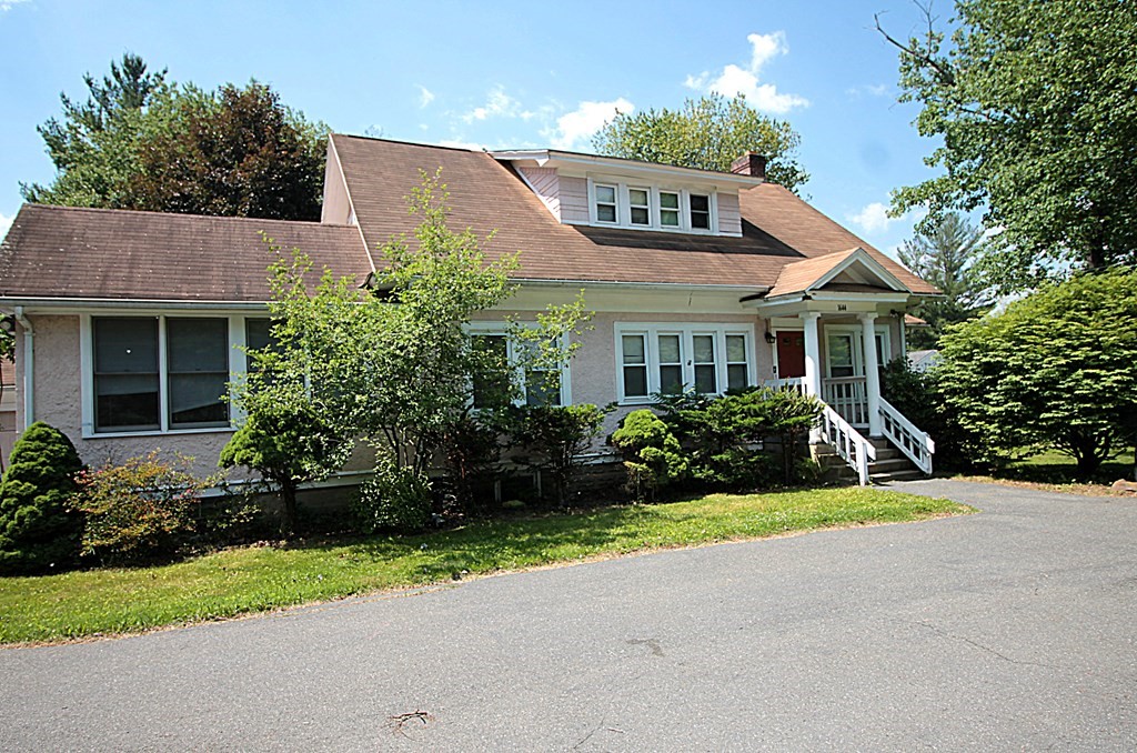 1644 Allen Street Springfield, MA 01118 - Photo 4 of 27 a front view of a house with a yard and trees