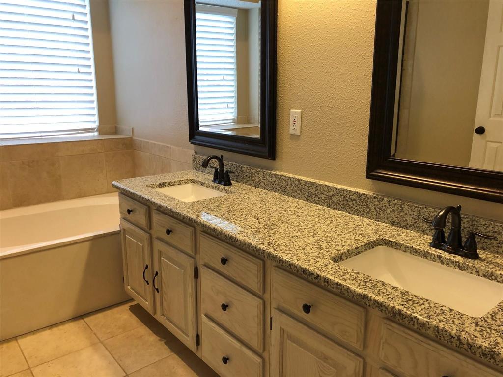 8301 Bells Street Frisco, TX 75035 - Photo 15 of 24 a bathroom with a granite countertop sink and a mirror