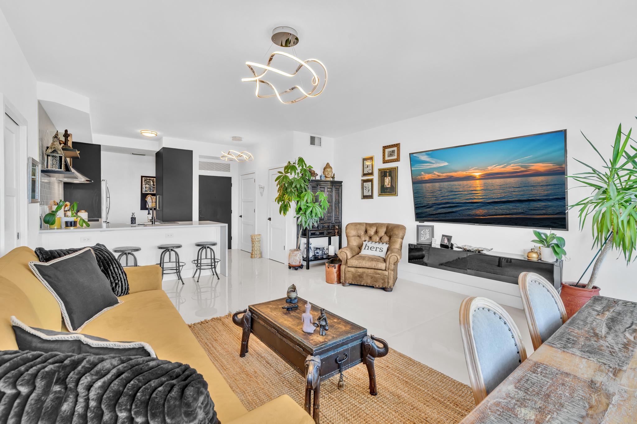 701 East Camino Real, Unit 12G Boca Raton, FL 33432 - Photo 13 of 82 a living room with furniture and a flat screen tv