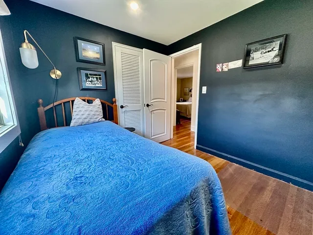 a bed sitting in a bedroom next to a window