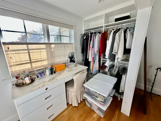 a view of walk in closet with clothes and shoes