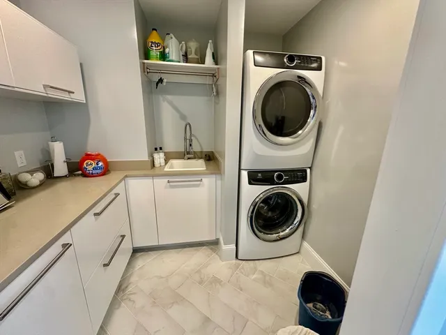 a utility room with sink dryer and washer