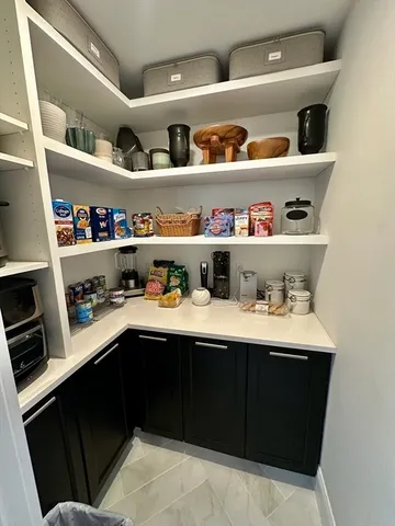a view of cabinets a sink and wooden floor