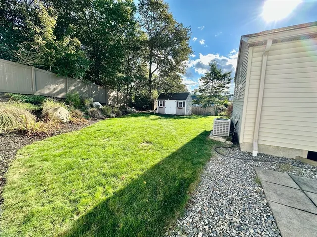 a view of a backyard with small cabin