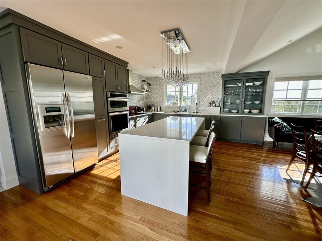 3 Day Circle Woburn, MA 01801 - Photo 7 of 42 a large kitchen with lots of counter space a refrigerator and chairs