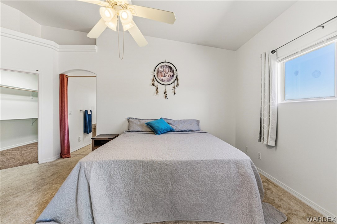 9332 Branded Road Kingman, AZ 86401 - Photo 15 of 44 a bedroom with a bed and a chandelier