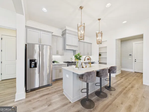 a kitchen with a sink a stove and chairs