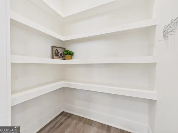 a kitchen with white cabinets stainless steel appliances and dining table