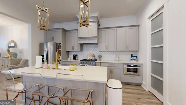 a kitchen with stainless steel appliances a table and chairs in it