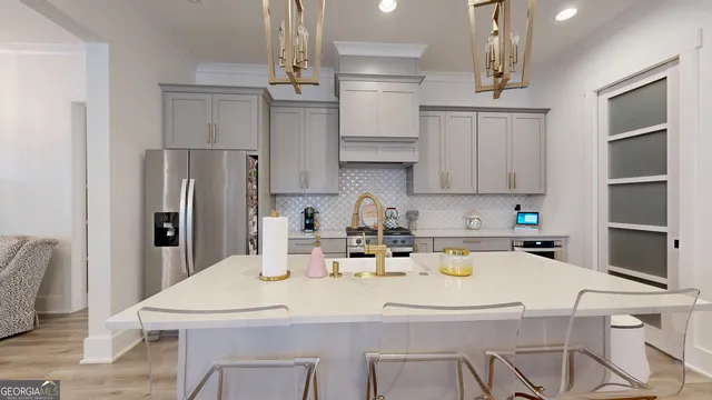 a kitchen with stainless steel appliances granite countertop a sink dishwasher and cabinets with wooden floor