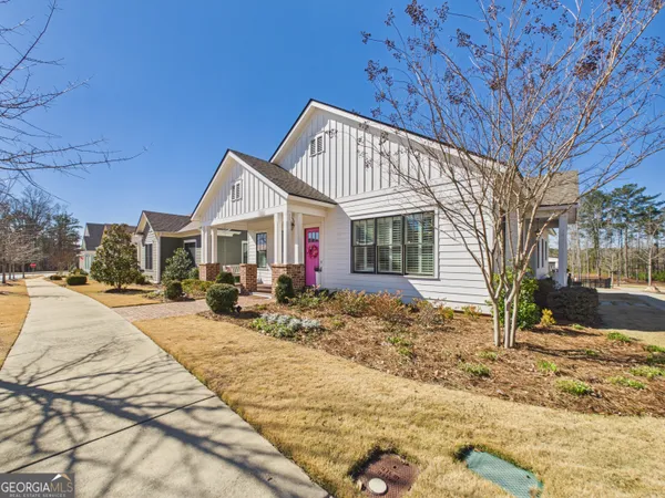 a view of a house with a yard covered in snow
