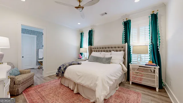 a bedroom with a bed and a flat tv screen on dresser