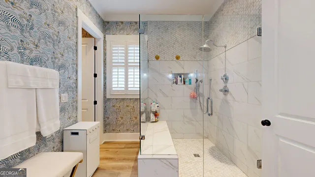 a view of walk in closet with clothes