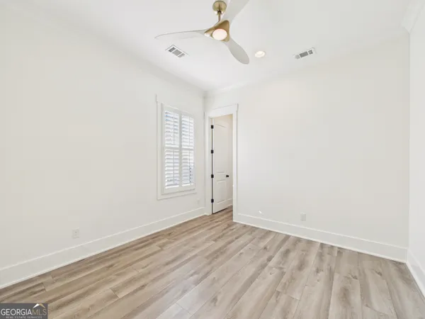 a front view of a house with outdoor seating yard and potted plants