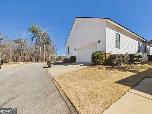 a view of a house with snow on the road