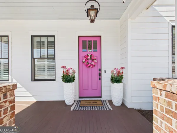 a living room with furniture a chandelier and a fireplace