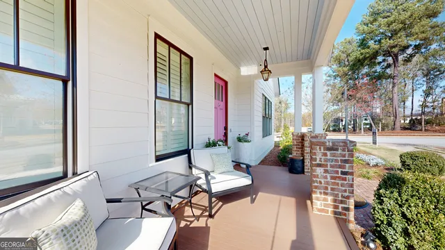 a balcony with furniture and a potted plant