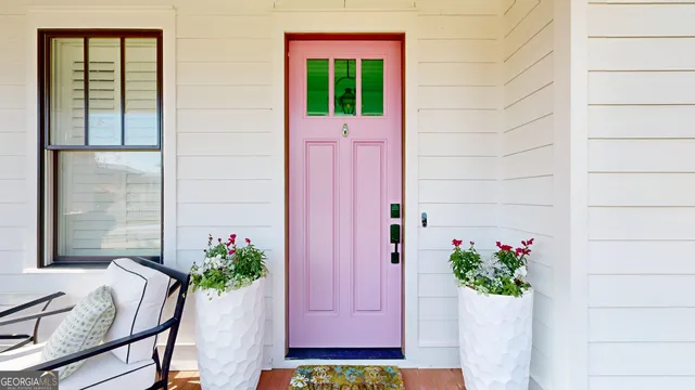 a living room with fireplace furniture and a large window