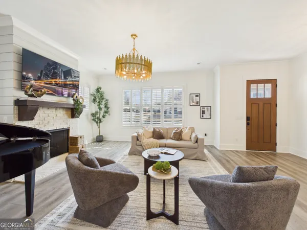 a living room with furniture a rug and a chandelier