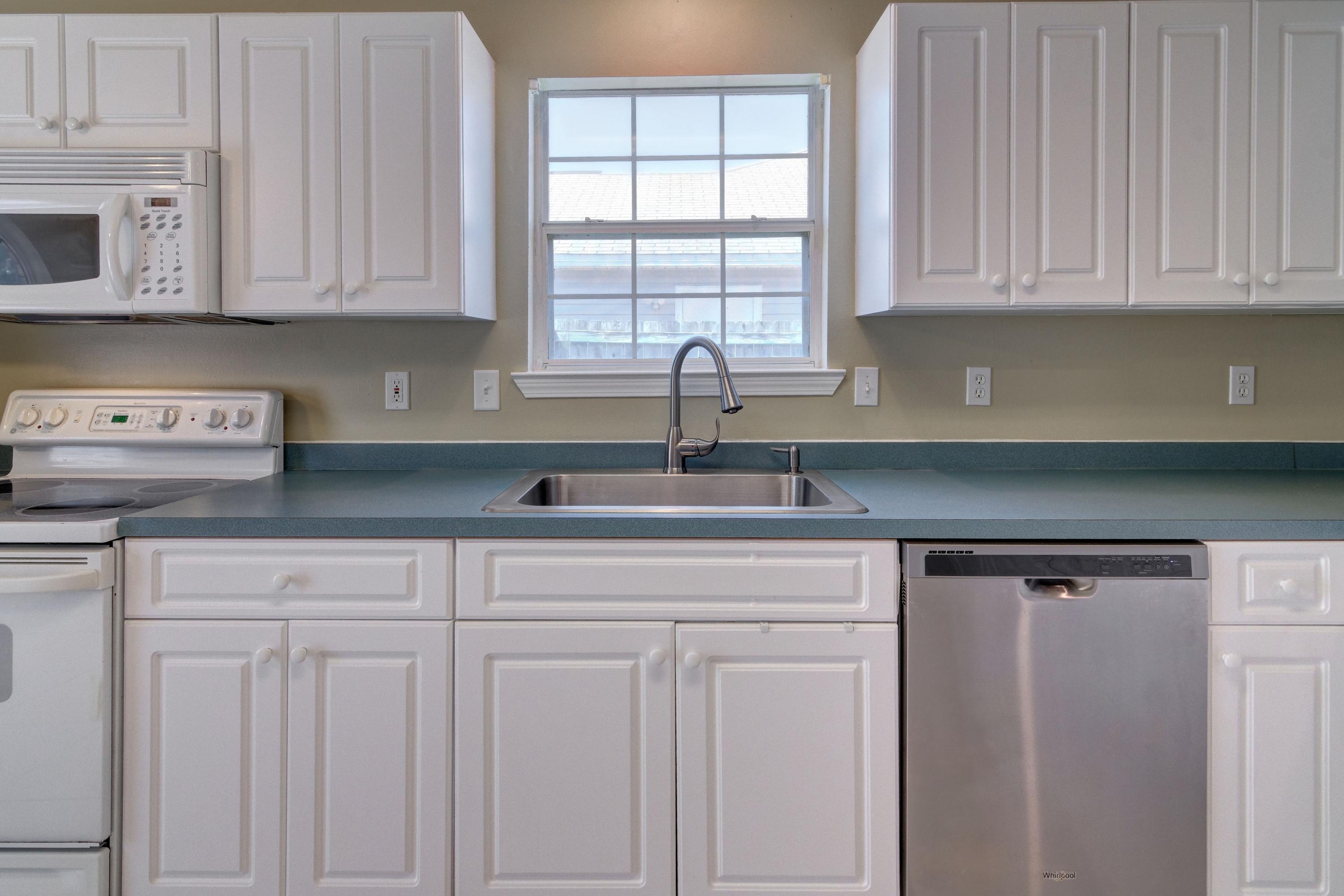 1774 Old Ranch Road Fort Walton Beach, FL 32547 - Photo 11 of 47 a kitchen with white cabinets and a window