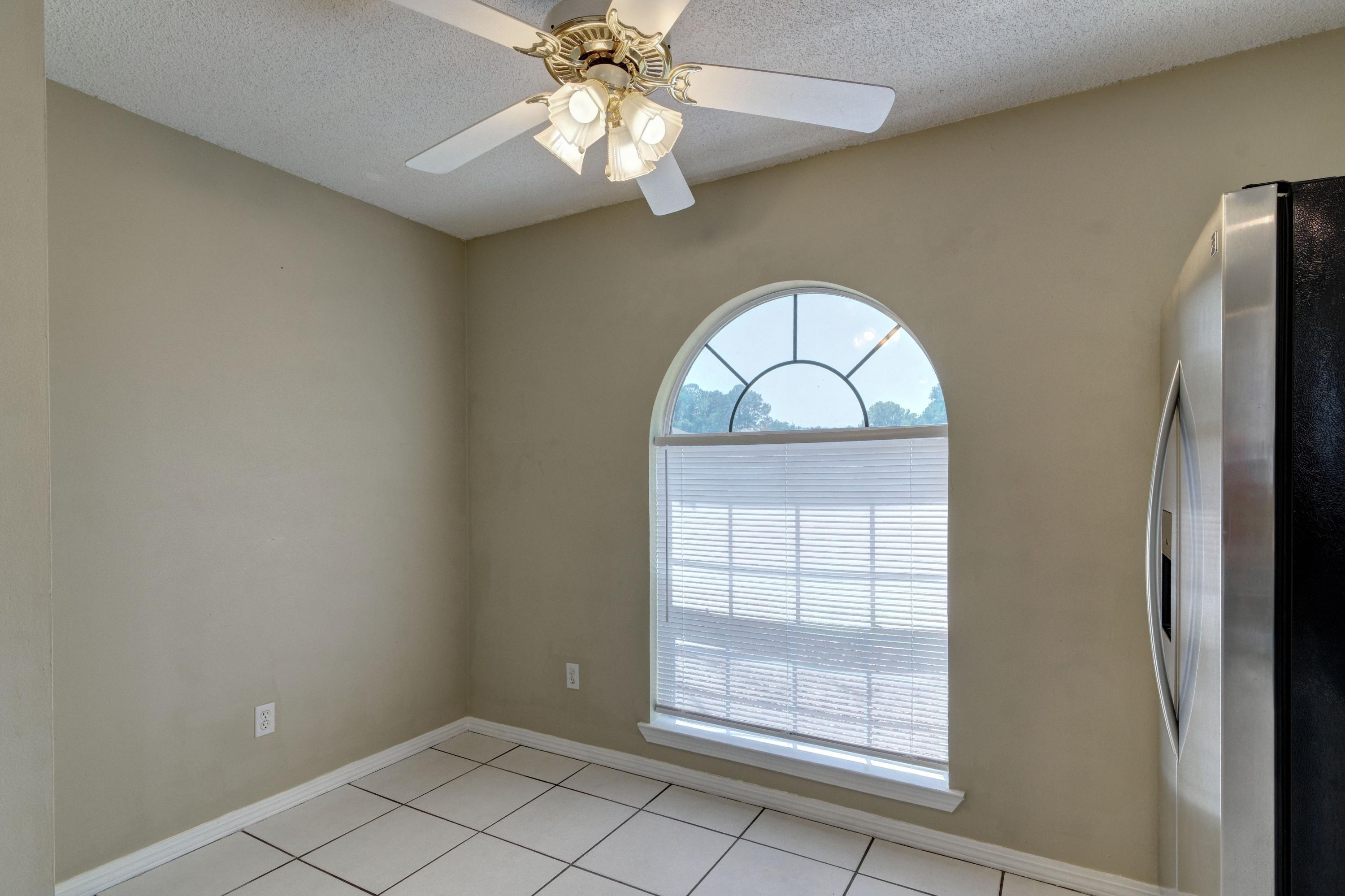 1774 Old Ranch Road Fort Walton Beach, FL 32547 - Photo 13 of 47 an empty room with windows and ceiling fan
