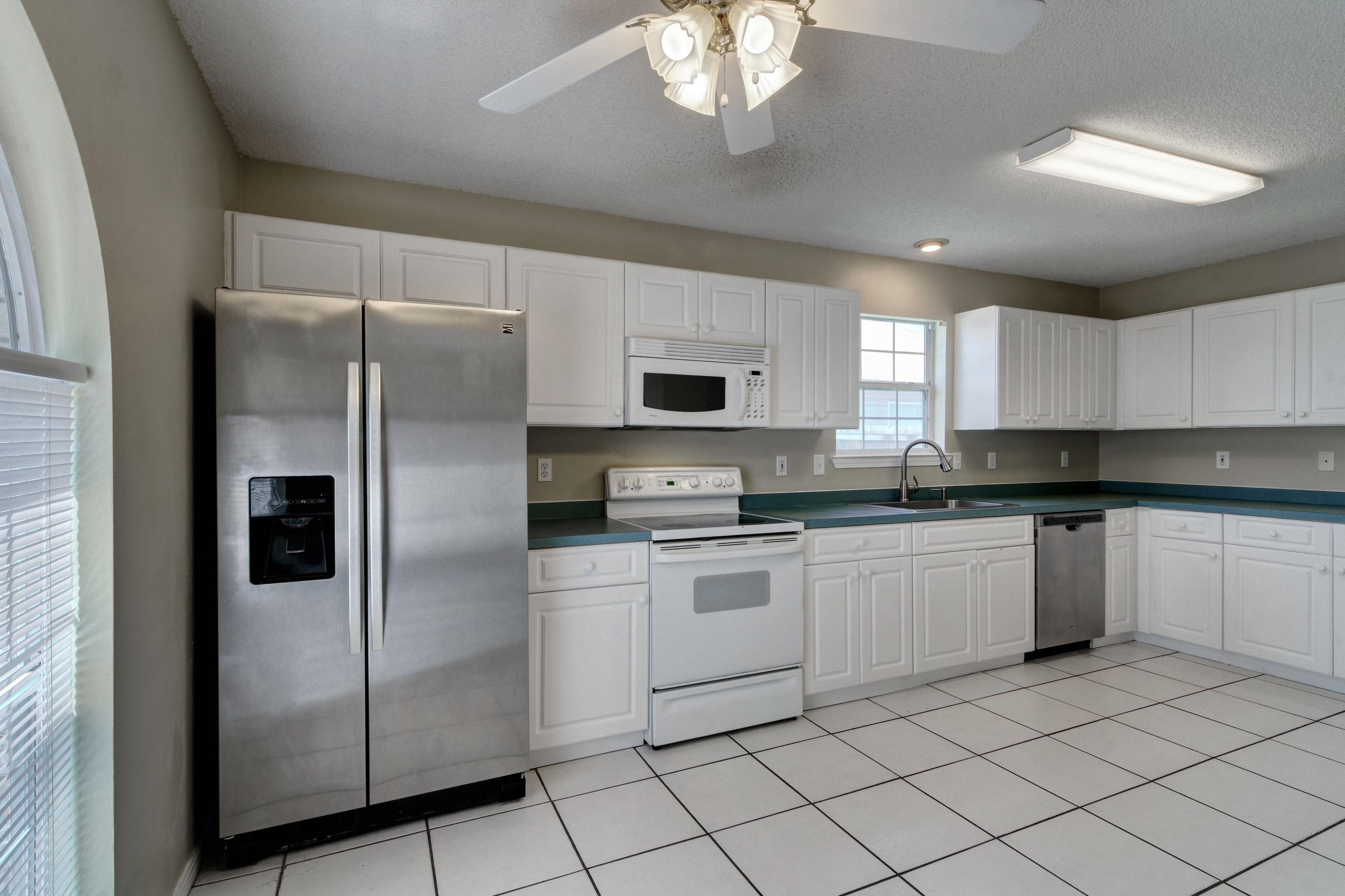1774 Old Ranch Road Fort Walton Beach, FL 32547 - Photo 15 of 47 a kitchen with stainless steel appliances granite countertop a refrigerator and a stove top oven