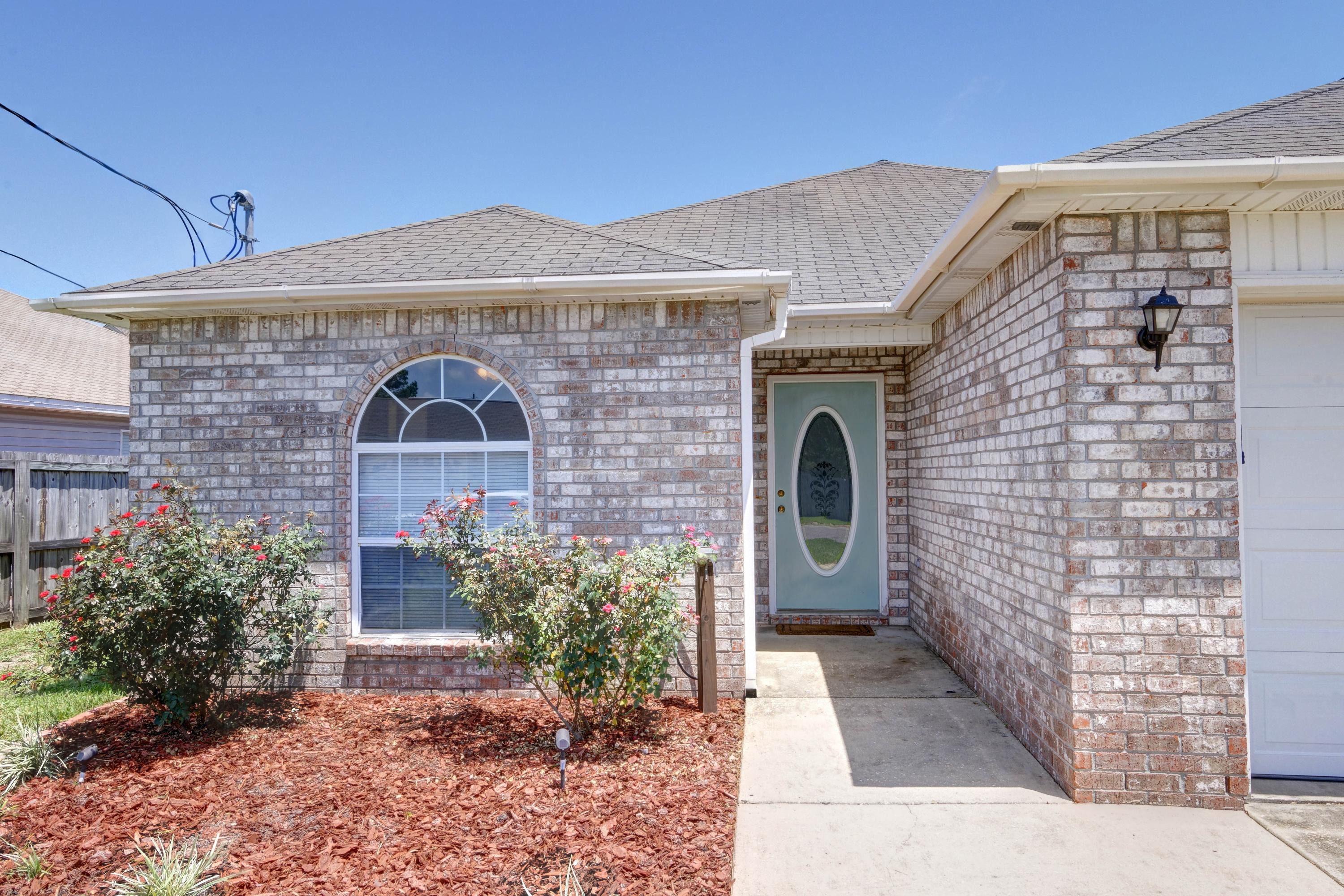 1774 Old Ranch Road Fort Walton Beach, FL 32547 - Photo 2 of 47 a front view of a house with garden