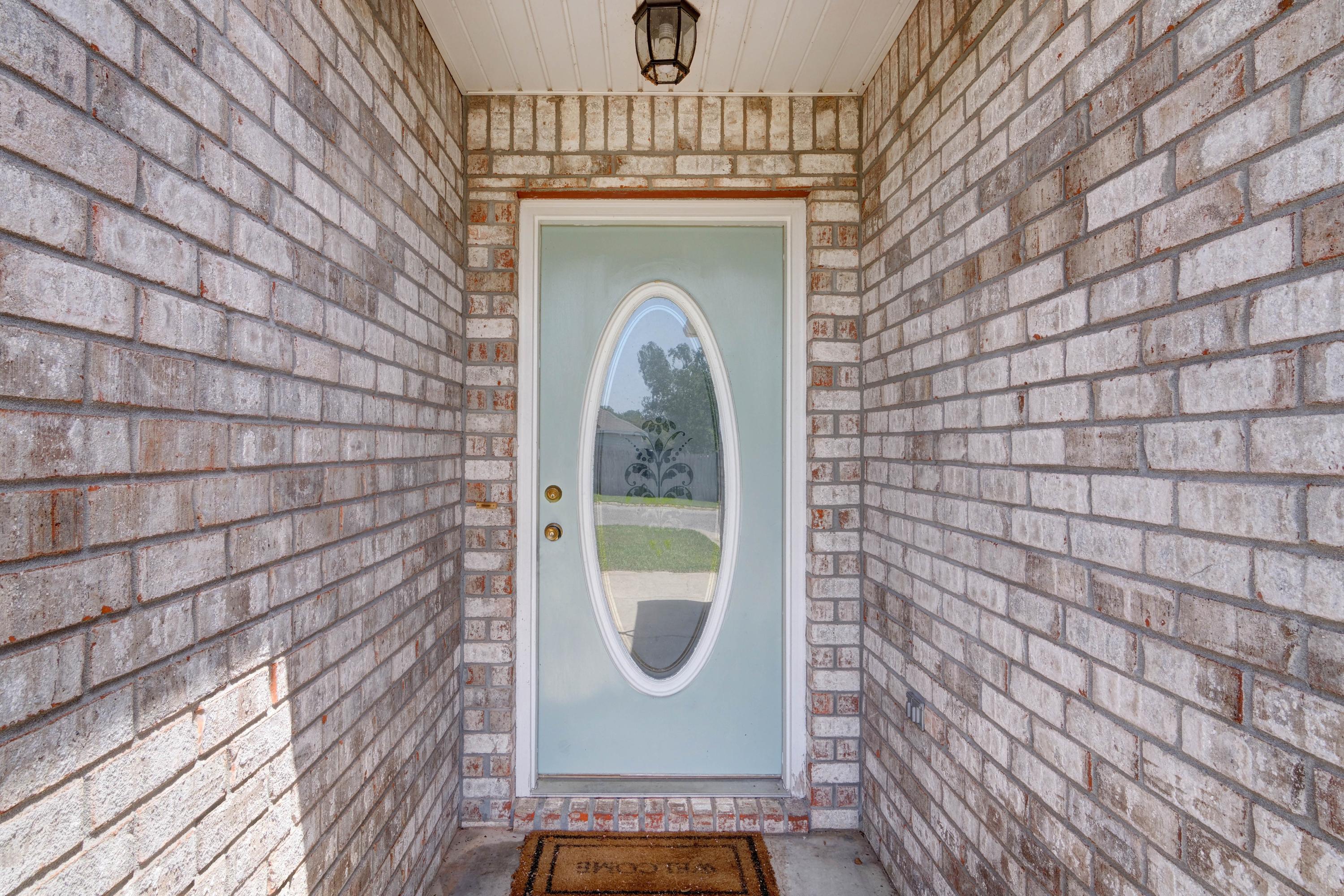 1774 Old Ranch Road Fort Walton Beach, FL 32547 - Photo 3 of 47 a view of a door of the house with a porch