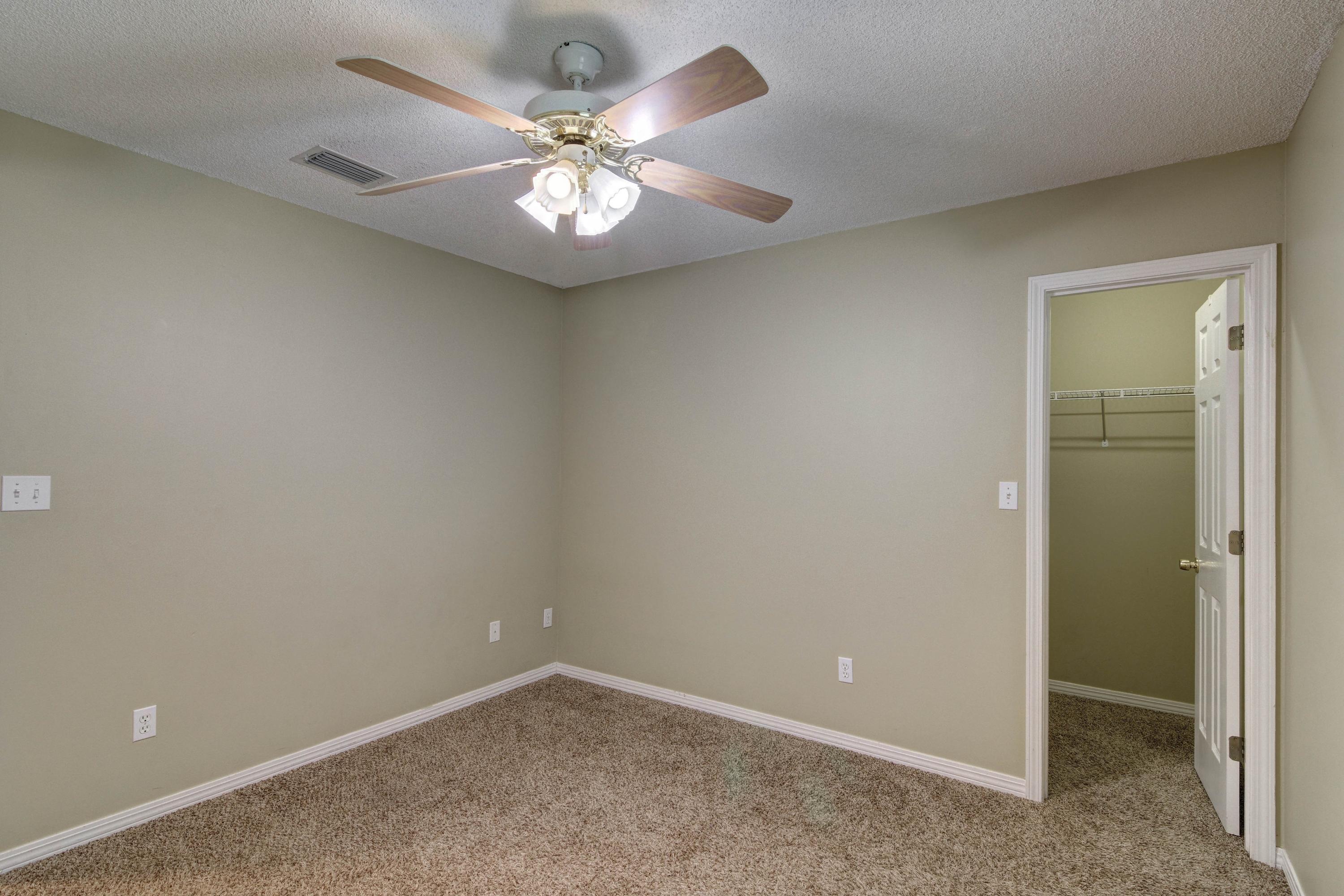 1774 Old Ranch Road Fort Walton Beach, FL 32547 - Photo 37 of 47 an empty room with a chandelier fan and closet