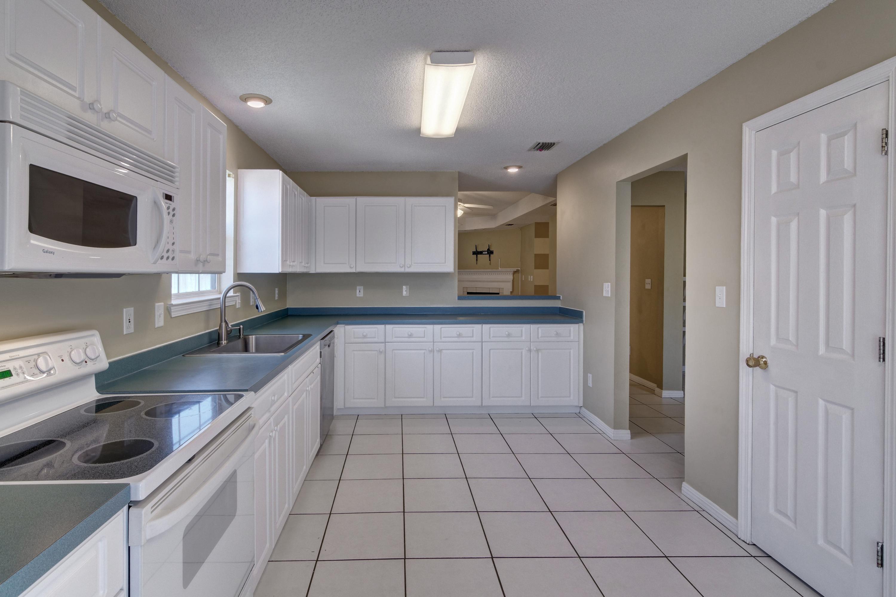 1774 Old Ranch Road Fort Walton Beach, FL 32547 - Photo 8 of 47 a kitchen with a sink a microwave and cabinets
