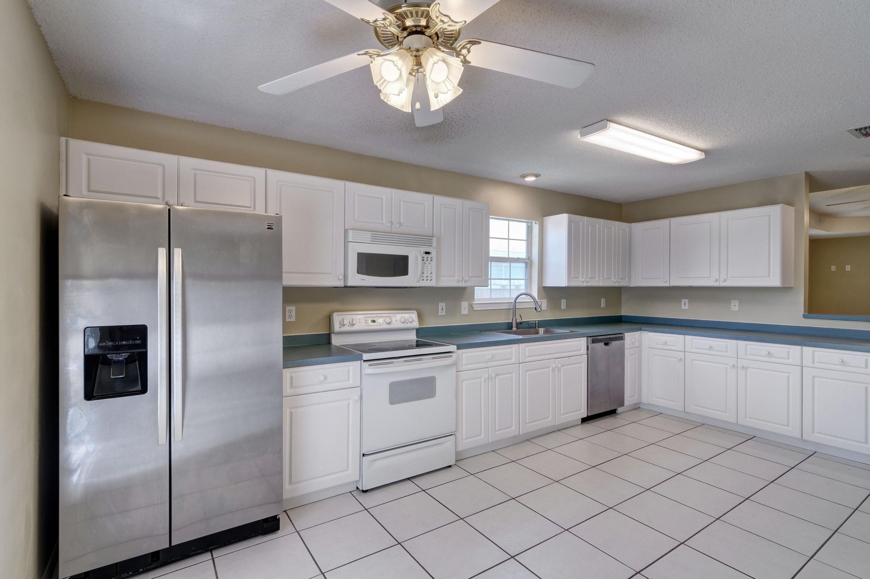 1774 Old Ranch Road Fort Walton Beach, FL 32547 - Photo 9 of 47 a kitchen with a refrigerator a sink and dishwasher