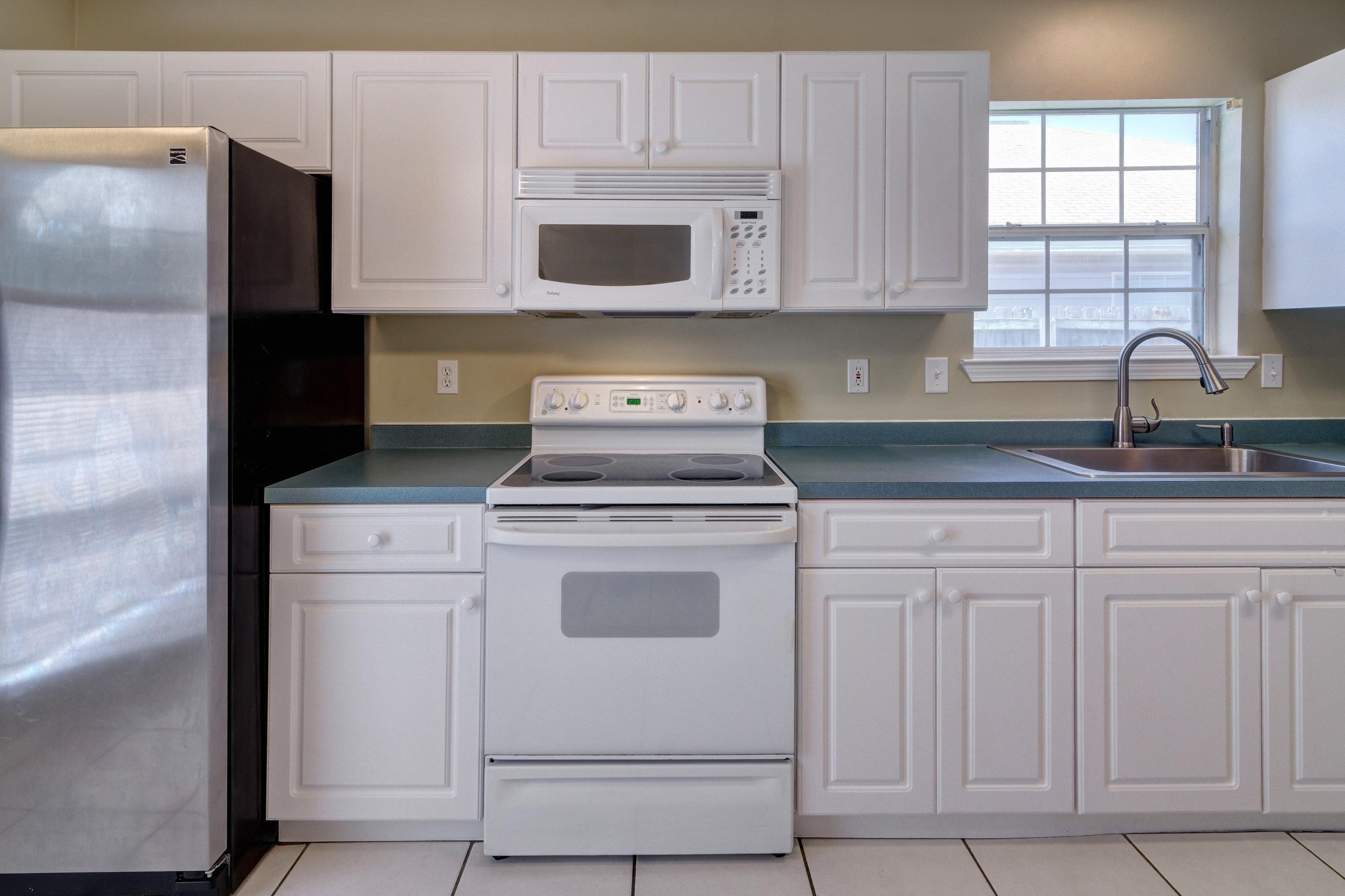 1774 Old Ranch Road Fort Walton Beach, FL 32547 - Photo 10 of 47 a kitchen with granite countertop white cabinets white stainless steel appliances and a sink